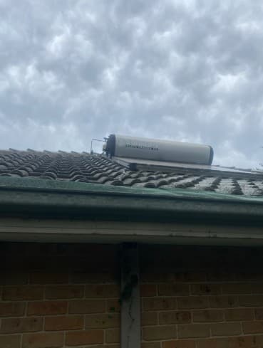 Roof-mounted solar hot water equipment photographed during a service visit